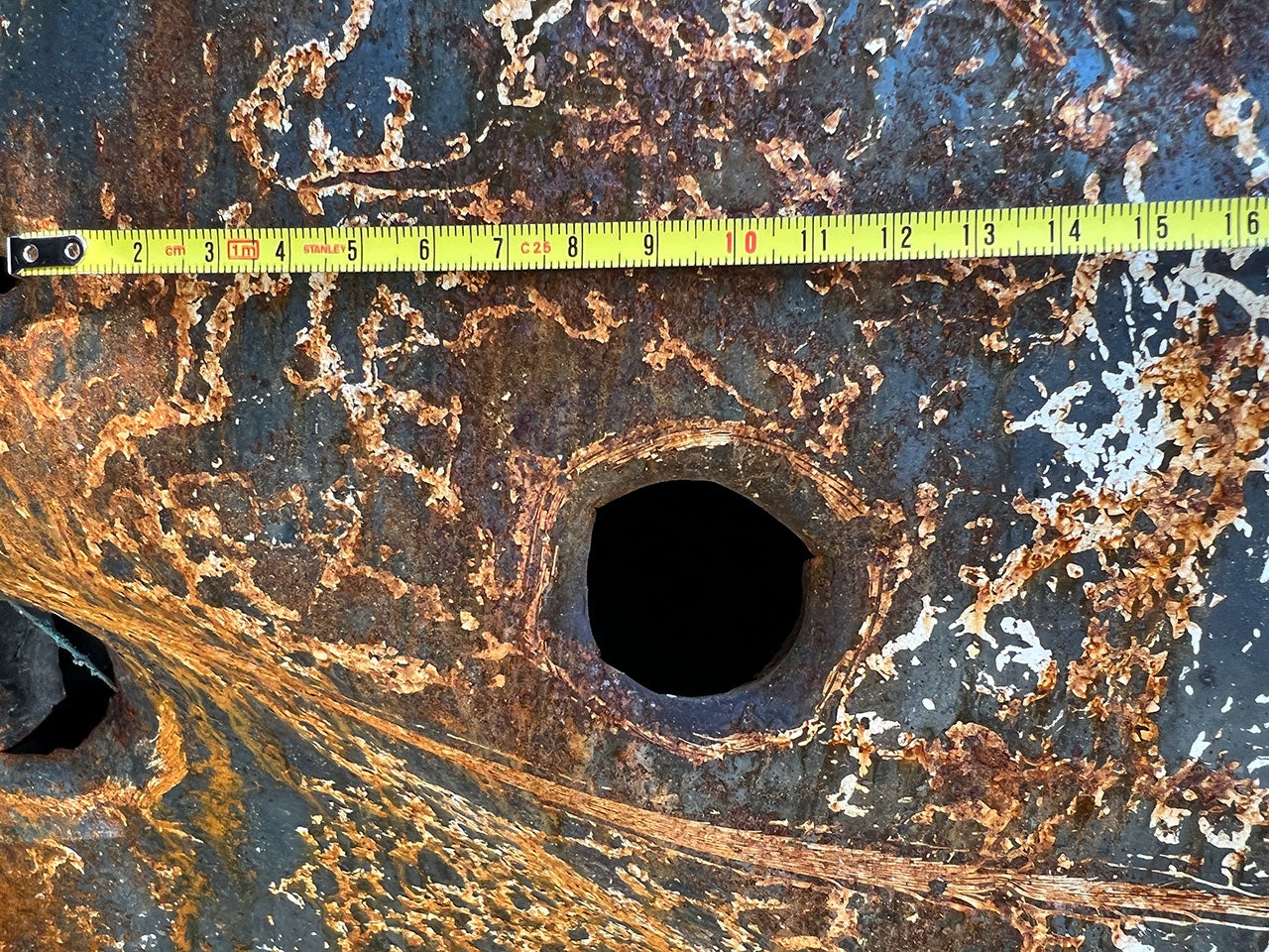 A large caliber bullet hole on the wreckage of a Tajik ambulance, which was attacked near a bridge by the border in Chorbog on September 16, 2022, along with another ambulance and a car carrying civilians.