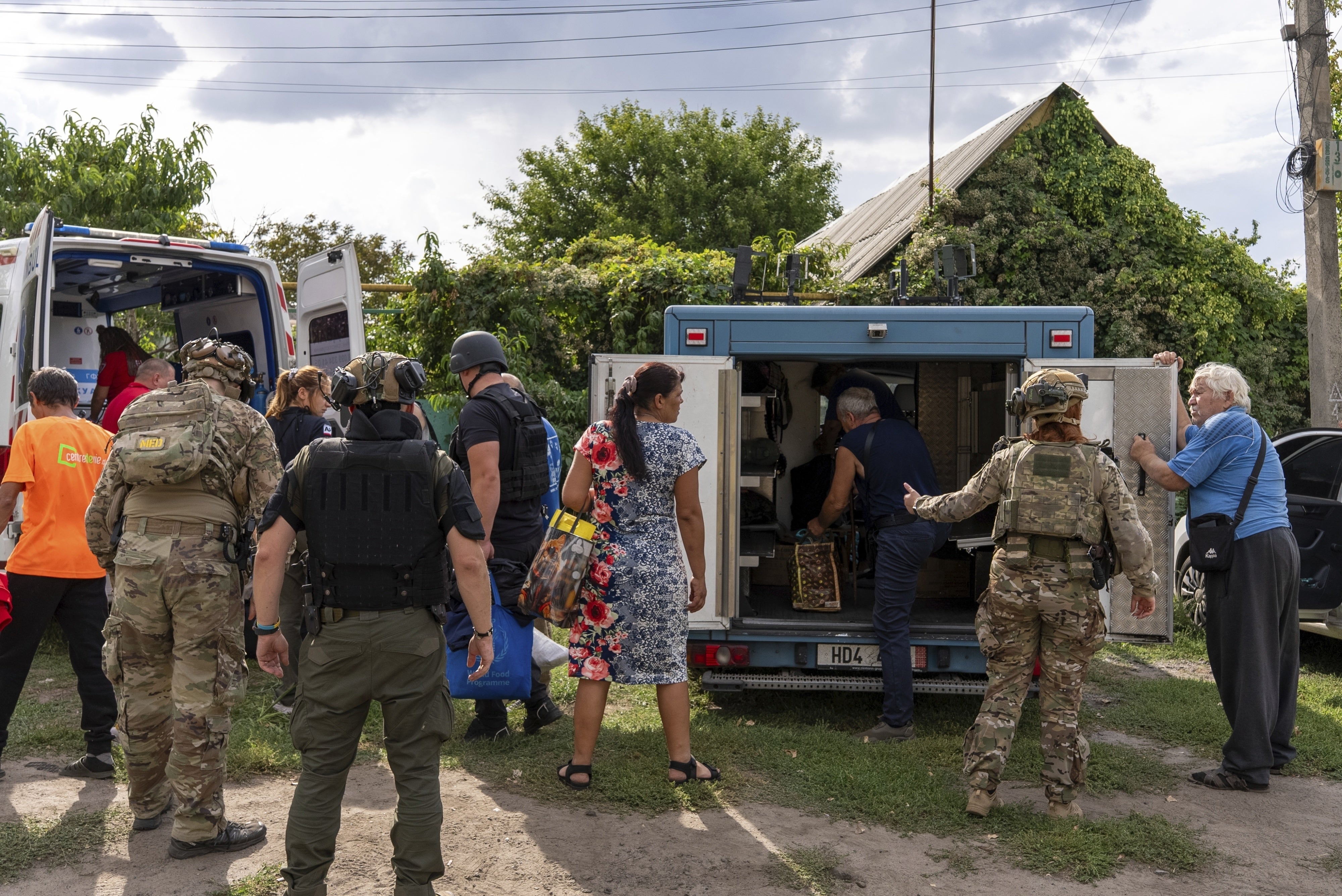 Policemen and medics help move people from an armored car to an ambulance in the village of Yarova,  Donetska region. On September 9, 2025, Yarova was hit by a Russian aerial strike, which killed dozens of civilians. 