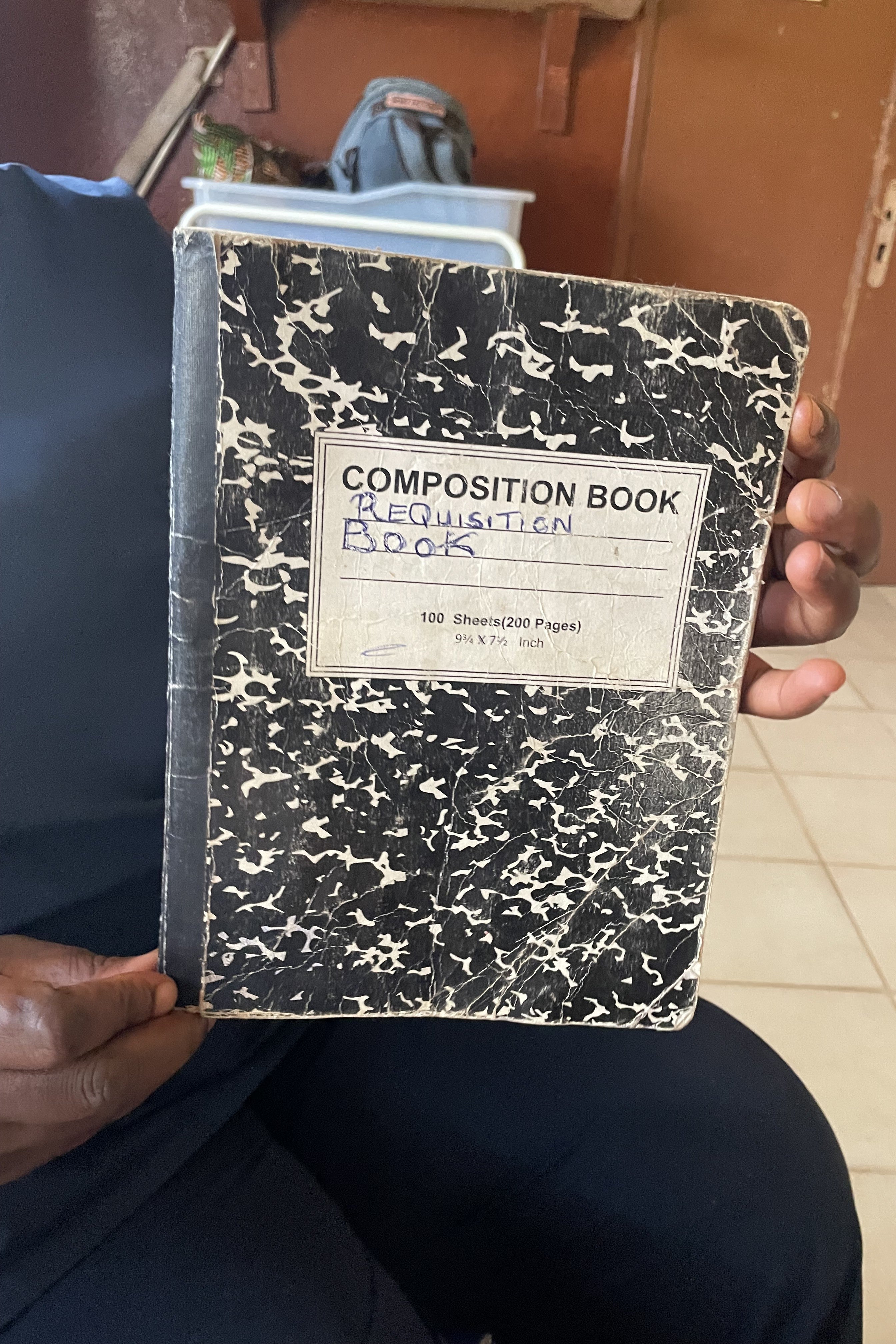 A person holds up a notebook