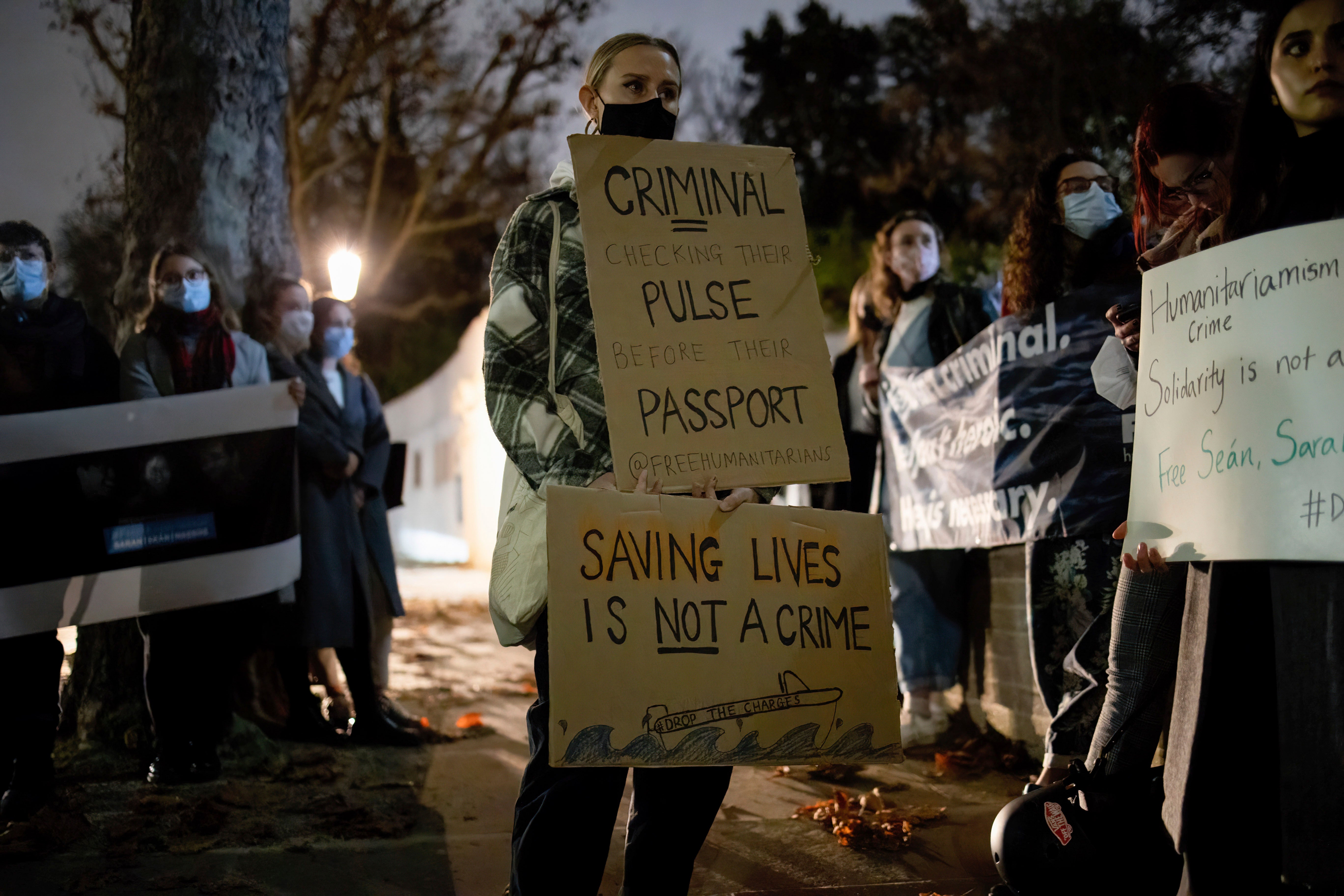 Protesters hold placards in solidarity with humanitarians who were still detained in Greece, November 18, 2021.