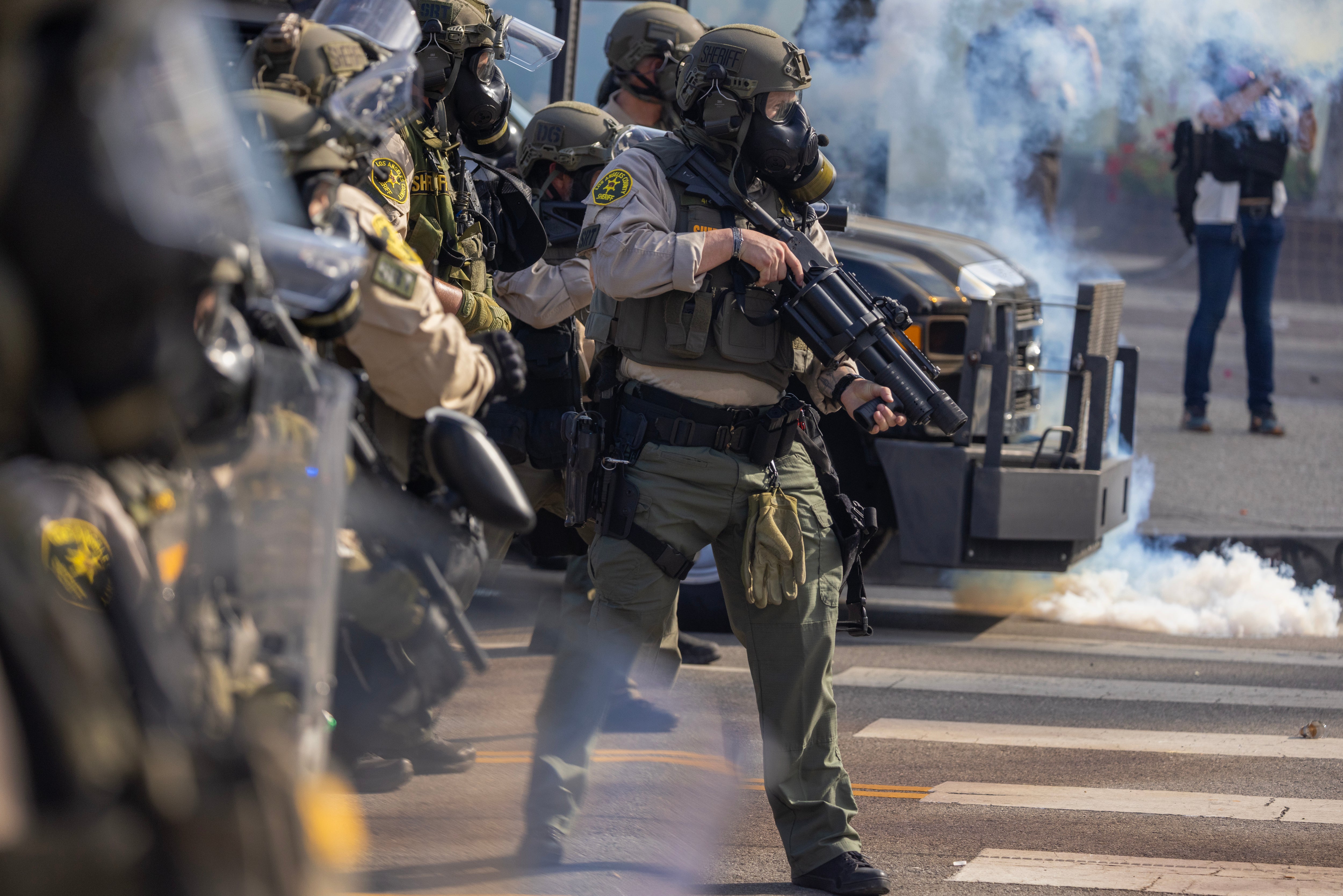 Sheriff deputies wield less-than-lethal munitions and tear gas during a "No Kings" protest in response to a series of federal immigration raids in Los Angeles, California, US, June 14, 2025. 