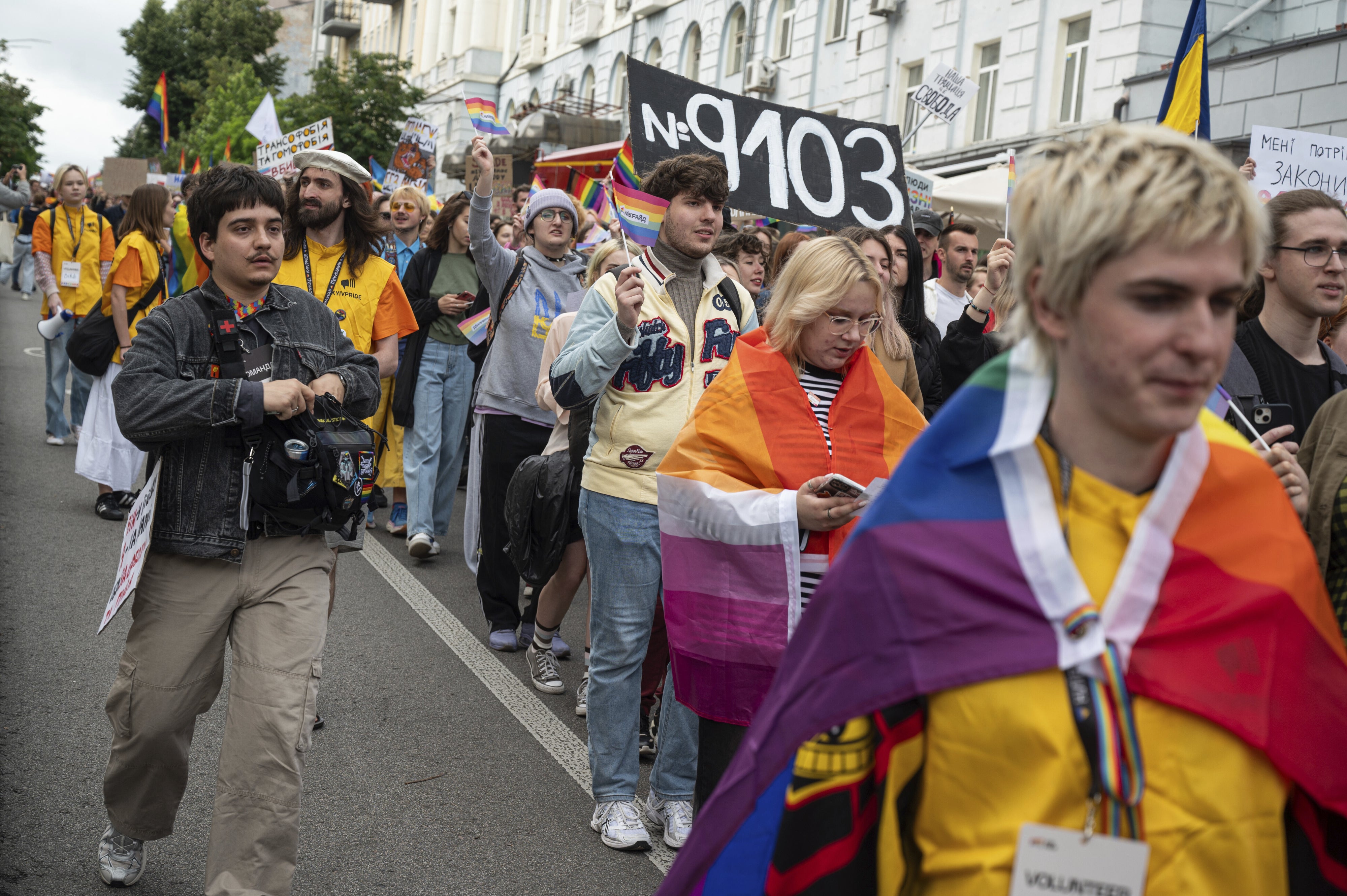 Participants at the 2025 Kyiv Pride Equality March display a placard supporting Draft Law 9103