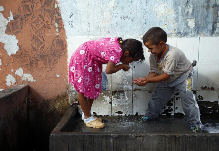 Roma refugees from Kosovo drink water at the Vrela Ribnicka camp in Podgorica, Montenegro on October 13, 2012