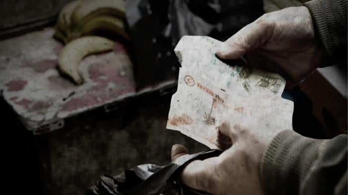 Hands holding Jordanian currency