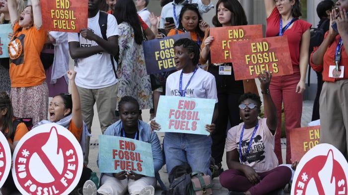 Vanessa Nakate, of Uganda, center, takes part in a protest against fossil fuels at the COP28 U.N. Climate Summit in Dubai, United Arab Emirates, December 5, 2023. 