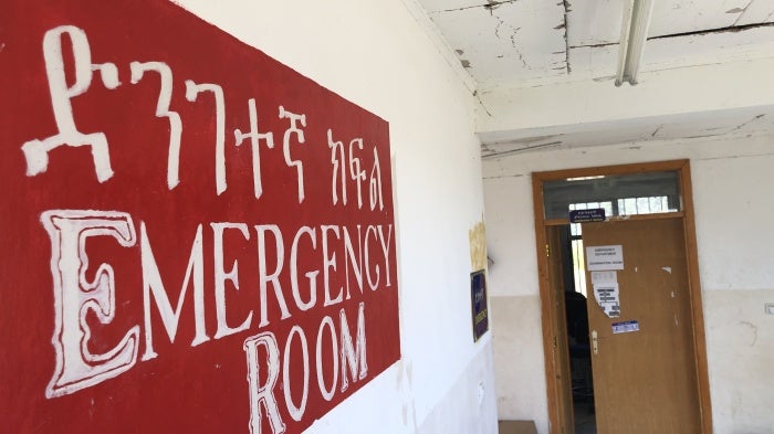 A sign that reads "Emergency Room" in a hospital 