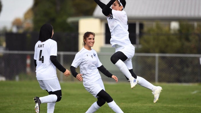 Afghan women's football team players celebrate a goal on April 24, 2022.
