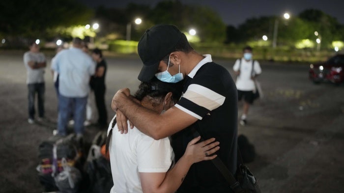 Asylum seekers embrace upon arriving in Panama City, Panama