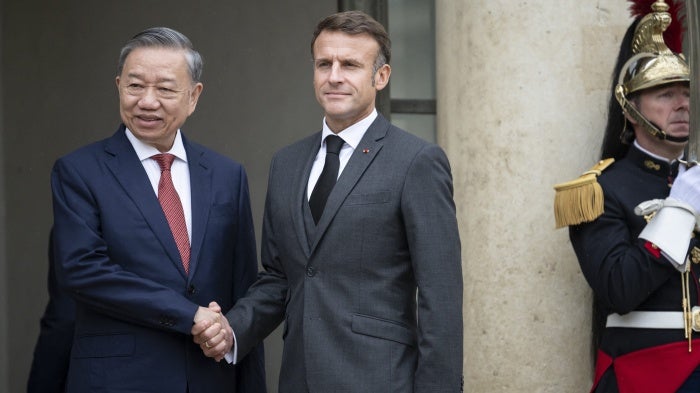France's President Emmanuel Macron (R) greets Vietnam's President To Lam at the Elysee Palace in Paris, October 7, 2024.