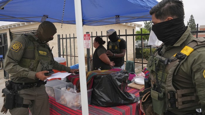 A woman is detained by US Border Patrol agents outside a Home Depot in Los Angeles, California, August 15, 2025.