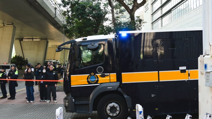 Prisoner transport vehicles outside the court in Hong Kong