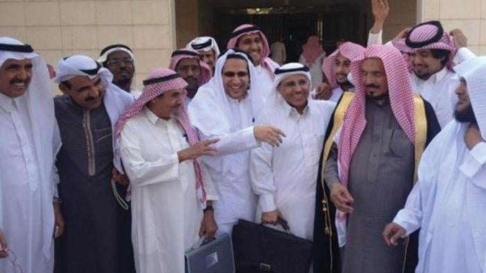 Saudi human rights activists gather outside the Criminal Court of Riyadh following a hearing in the trial of fellow activists Abdullah al-Hamid and Mohammed al-Qahtani. 