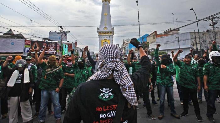 A group opposing the Lesbian, Gay, Bisexual and Transgender (LGBT) community prepares to confront a pro-LGBT group planning on staging a counter protest at Tugu Monument in Yogyakarta on Feb. 23. 
