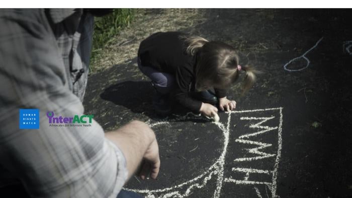 A father plays with his daughter, who was born with atypical sex characteristics. Despite pressure from doctors, the parents chose not to elect medically unnecessary surgeries on their child. 