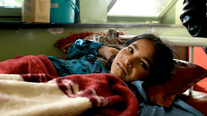 a photo of a child on a hospital bed in Afghanistan.