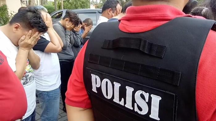 A photo showing members of the LGBT community in Indonesia being rounded up by Police.