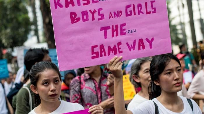 People take part in the 2018 Women's March rally in Jakarta on March 3, 2018. The participants were demonstrating for equal rights and an end to violence against women.