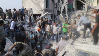 Rescue forces and others at work following a strike on a primary school in Minab, Iran, February 28, 2026. 