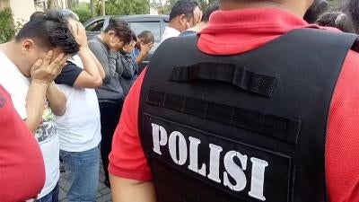 A photo showing members of the LGBT community in Indonesia being rounded up by Police.