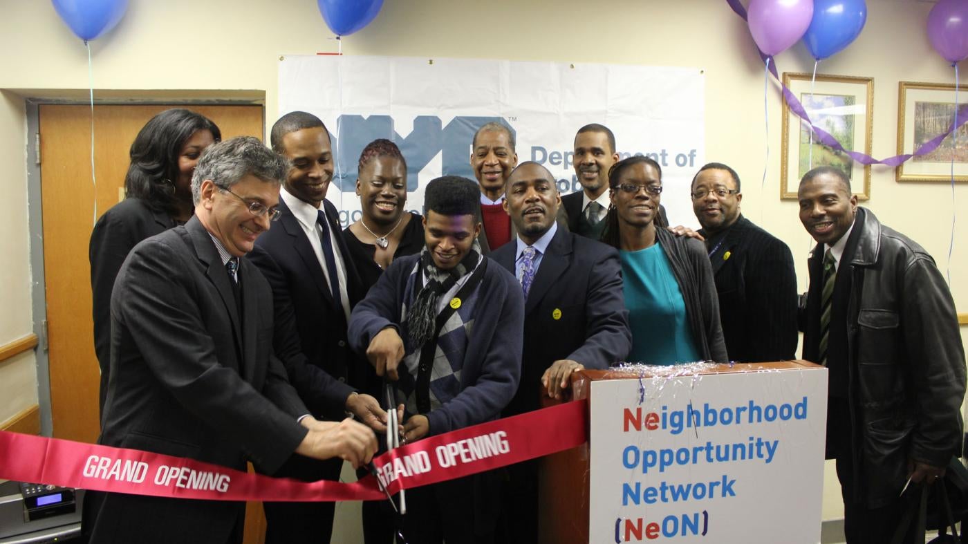 Former Commissioner Vincent Schiraldi and others cut a ribbon at the opening of the Neighborhood Opportunity Network at the New York City Department of Probation. 