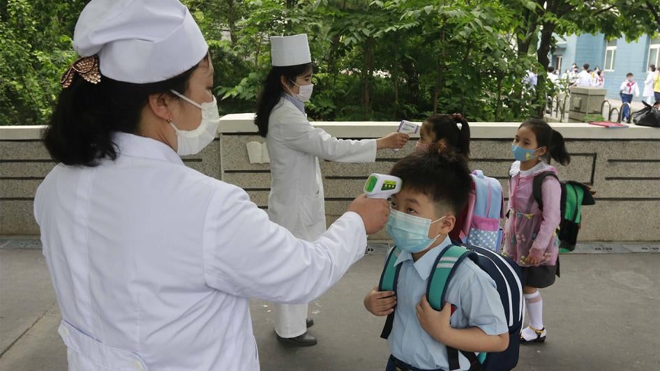 Kim Song Ju Primary school students have their temperatures checked before entering the school in Pyongyang, North Korea. 