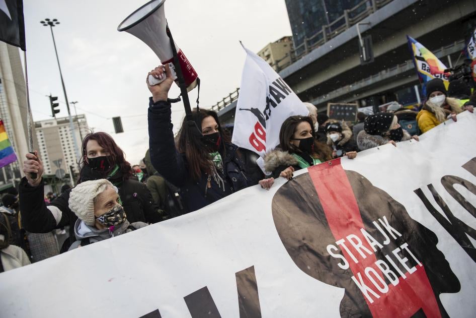 Protesters hold a banner of Strajk Kobiet (Women's Strike) during a protest in Warsaw on March 8,  International Women's Day, organized by the Women's Strike (Strajk Kobiet) against the ruling Law and Justice (PiS) party and the decision of the Constitutional Court.