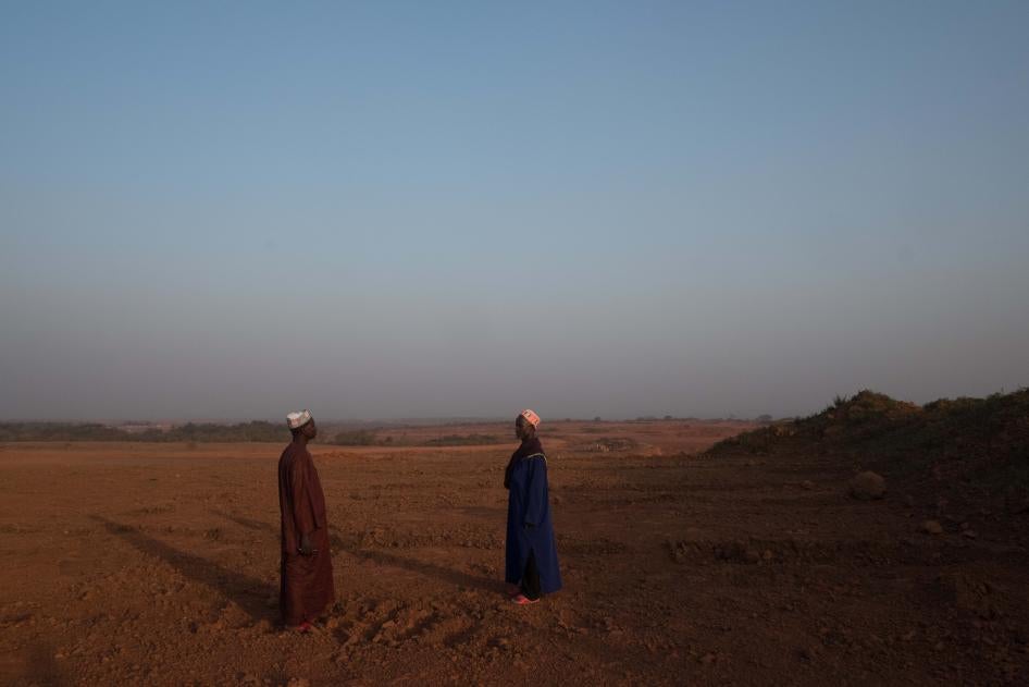 Two men standing in an empty field