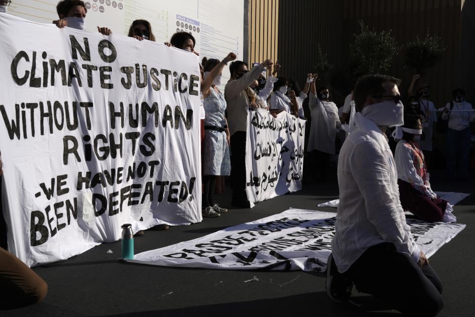 Demonstrators participate in a silent protest at the COP27.