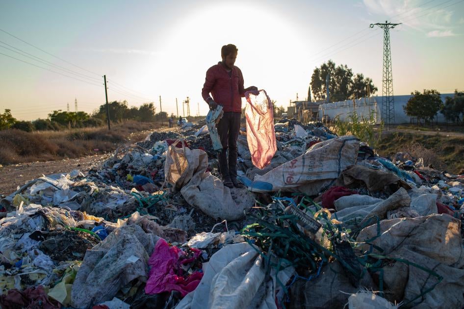 A man collects items from an illegal dump on November 29, 2020 in Adana, southern Turkey.