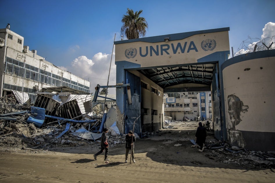 Palestinians examine damage to the United Nations Relief and Works Agency for Palestine Refugees (UNRWA) buildings