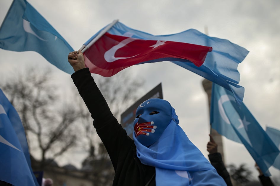 A person from the Uyghur community living in Türkiye protests against the visit of China's Foreign Minister Wang Yi to Türkiye, in Istanbul, March 25, 2021. 