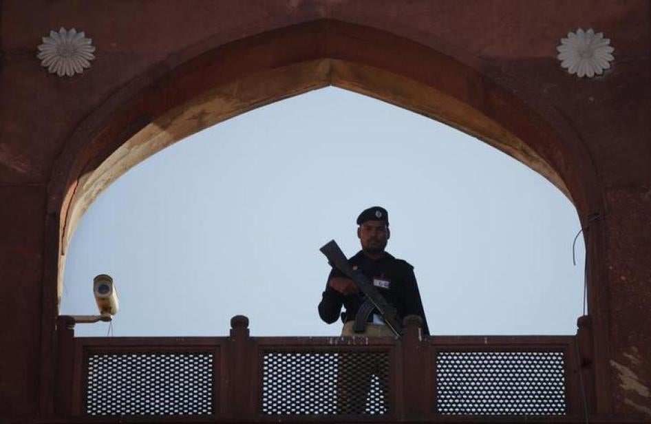 A police officer is framed by the architecture of Lahore's Badshahi Mosque while standing guard during a prayer session on Eid al-Adha November 7, 2011. Copyright Reuters