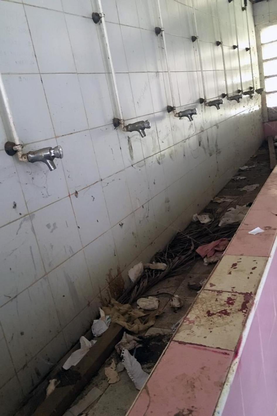 A bathroom at the high school, where there is no running water. 