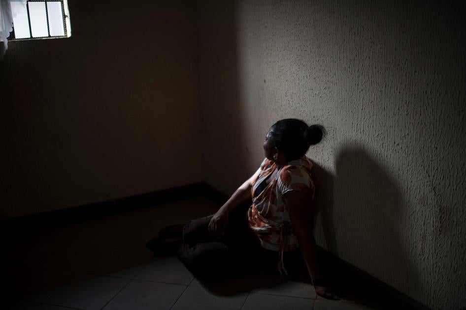 A Nigerian woman sits in a center in Benin City. 