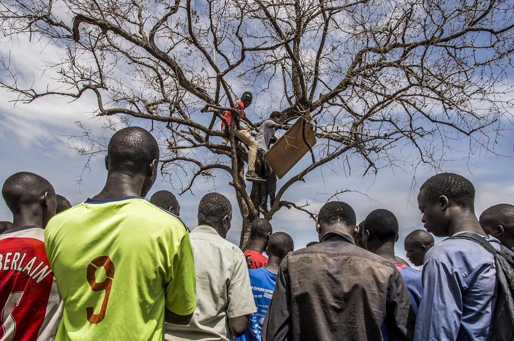 After registration at the Imvepi reception center, refugees wait for their names to be called for transport to their new home in the Bidibidi refugee settlement, in Uganda’s West Nile region, April 8, 2017. 