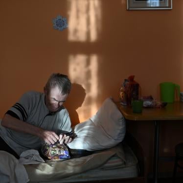 A resident in a nursing home in the village of Sosnovskoye in Omsk region, opens a bag with sweets during a visit of volunteers as part of the "Old Age for Joy" charity project.