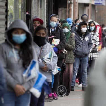 A line of people in face masks