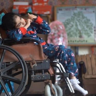 Deema Salha, an 11-year-old girl with cerebral palsy and an intellectual disability, in the yard of her home in the Gaza Strip. Deema uses a nebulizer when she has trouble breathing, which she cannot operate without electricity, putting her health at risk.