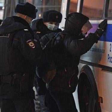 Police officers detaining Alexei Navalny's supporter at Vnukovo airport, Moscow, on January 17, 2021. © 2021 Emin Dzhafarov/Kommersant/Sipa via AP Images