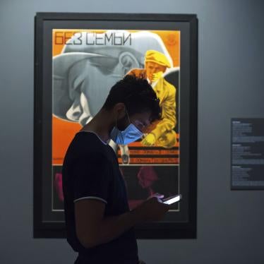 A young man wearing a face mask checks his mobile phone at the State Russian Museum, Saint Petersburg, May 26, 2020.