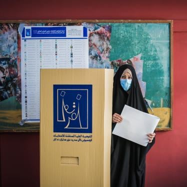 A woman casts her vote in the general elections on October 10, 2021 at a polling place in Baghdad.