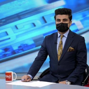 A tv anchor wears a face mask on the air