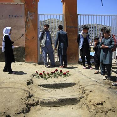 People put flowers outside a school the day after a deadly attack