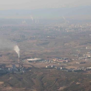 Smoke and steam rise from towers