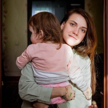 A woman holding her daughter in her arms