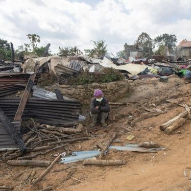 A man sits in front of a house in Shan State that was destroyed during fighting between Myanmar security forces and the Ta'ang National Liberation Army, January 10, 2023. 