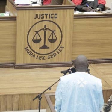 A man stands in front of a judge