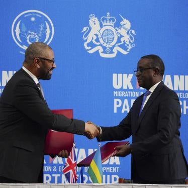 Britain's Home Secretary James Cleverly, left, and Rwandan Minister of Foreign Affairs Vincent Biruta shake hands after signing a new treaty in Kigali, Rwanda, December 5, 2023.