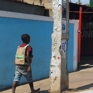 A boy wears a “bullet-proof vest” made of cardboard while walking on the streets of Maputo, Mozambique, November 5, 2024.
