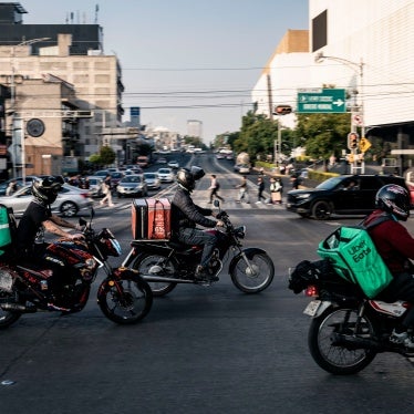Delivery workers carry Uber Eats and Didi bags in Mexico City, Mexico, on December 12, 2024. 